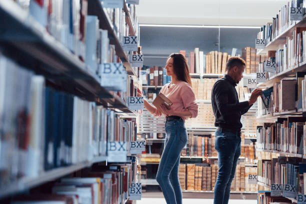 istock Enjoying the process. Multiracial students in the library searching for the information together 1149725040