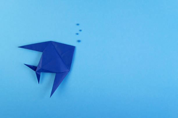 istock Origami tropical fish on sky blue minimalistic background 1149727011