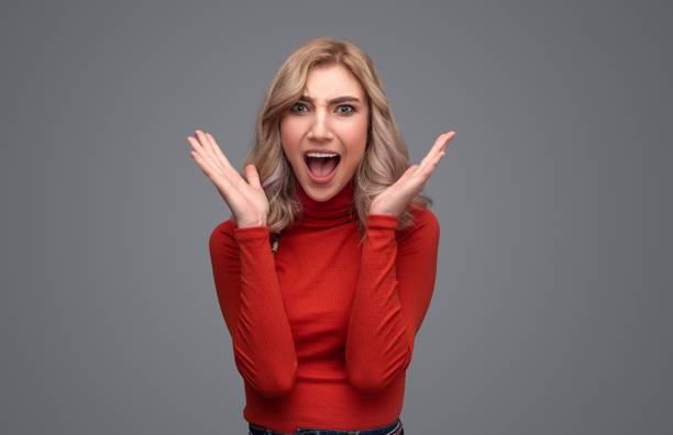 istock Excited lady in sweater screaming 1149727042