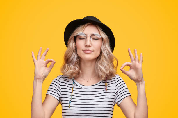 Stylish lady meditating with closed eyes