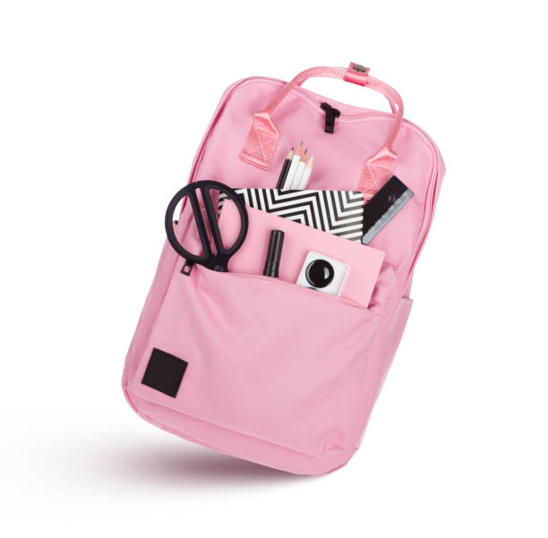 istock Pink school backpack with educational supplies isolated on white background 1149727694