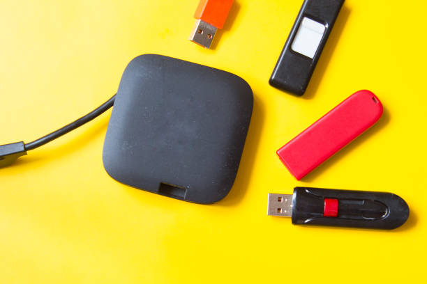 istock Black USB HUB with usb stick flash drives on yellow background. Top view. 1149728934