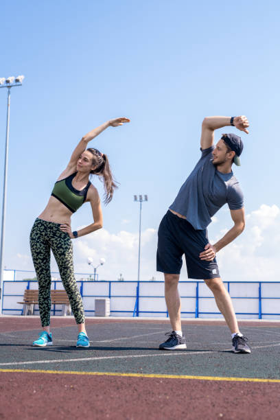 istock Young Couple Stretching on Track 1149732942