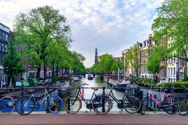 city view of amsterdam and the wester church with bicycles - amstel river amsterdam architecture bridge imagens e fotografias de stock