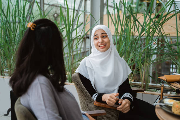 istock arab muslim woman in conversation 1149733717