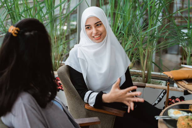 arab muslim woman explain while meeting with friend in cafe