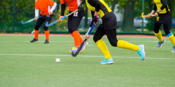 istock Low Section Of People Playing Hockey On Field 1149736110