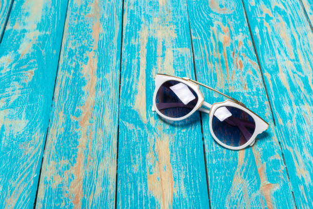 istock sunglass on the wooden background 1149736567