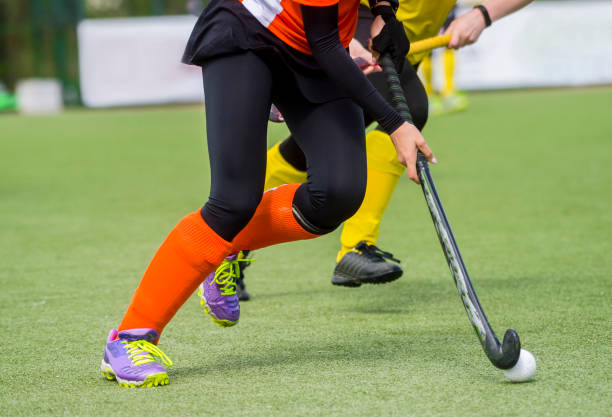 istock Low Section Of People Playing Hockey On Field 1149736663