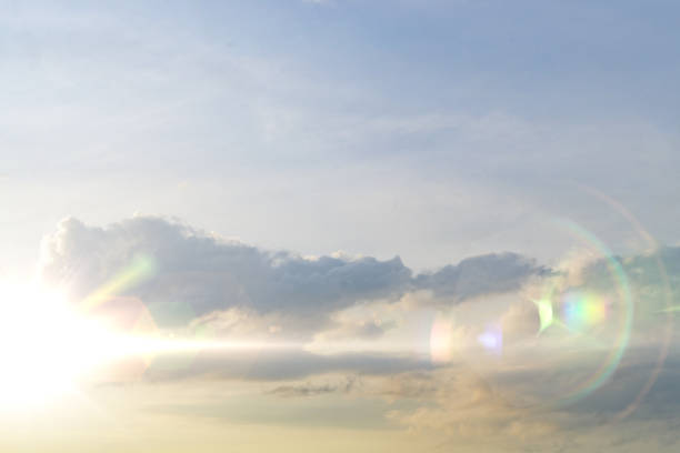 istock cloudy sky at sunset time, yellow sun rays or beams go through the cloud 1149738983