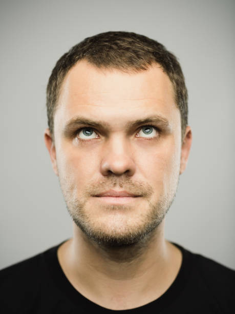 istock Portrait of real caucasian man with blank expression looking up 1149741477