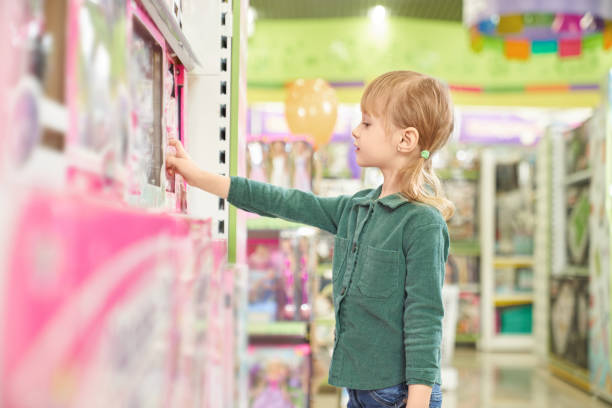 istock Kid choosing toys for purchase in big store. 1149741632