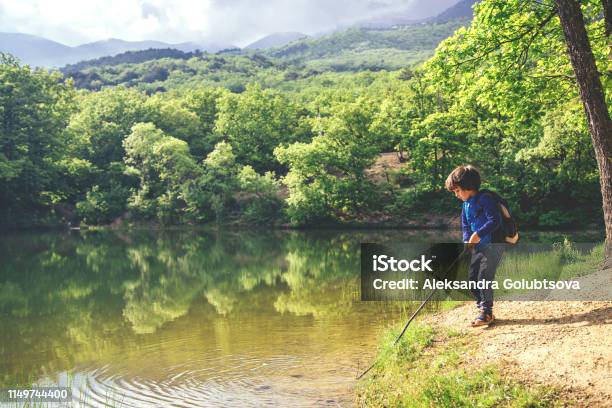 Child Play Fishing Near Lake Stock Photo - Download Image Now - Child, Boys, Mountain