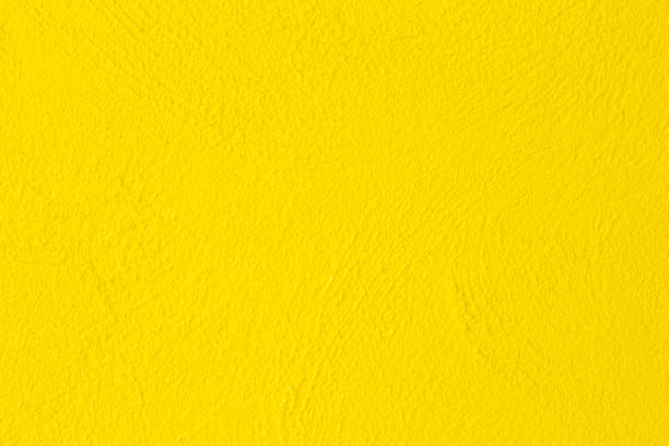 テクスチャの背景のためのコンクリートの壁黄色の色 - orange wall textured paint ストックフォトと画像