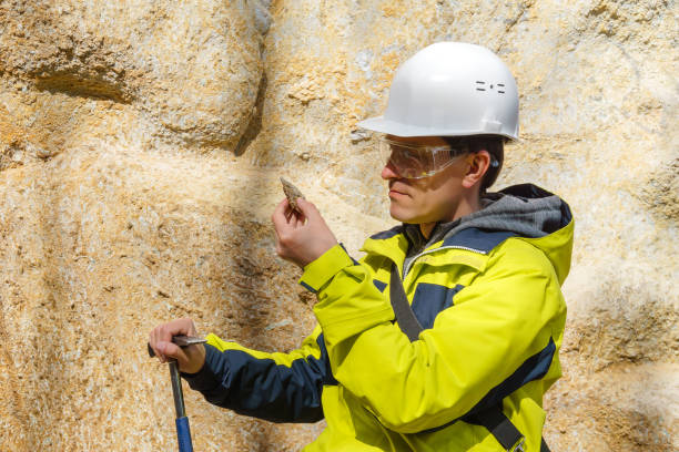 istock geologist examines a sample of stone outdoor 1149746308
