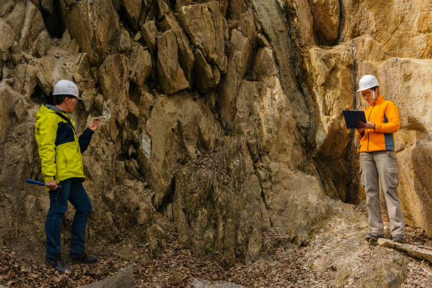 geologists against the rocks in the canyon male and female geologists takes a sample of the mineral and record data in a canyon geologist stock pictures, royalty-free photos & images