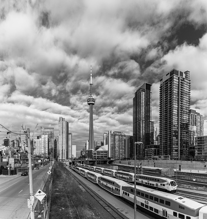 A black and white picture of the CN Tower next to the railroad tracks (Toronto).