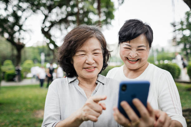 istock Two Taiwanese Ladies Smiling While Looking At Smartphone Together 1149747861