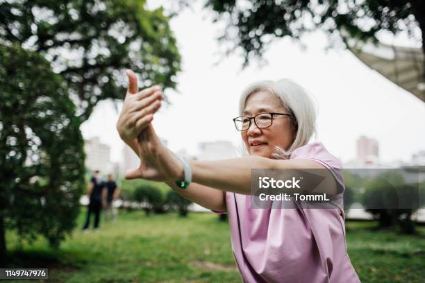 Taiwanese Lady Staying Fit With Tai Chi At The Park Stock Photo - Download Image Now