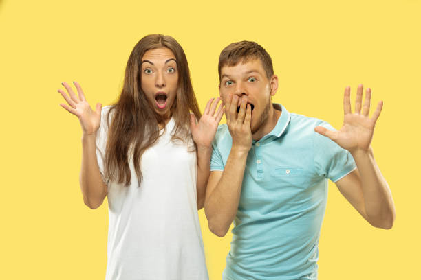 istock Beautiful couple isolated on yellow studio background 1149748979