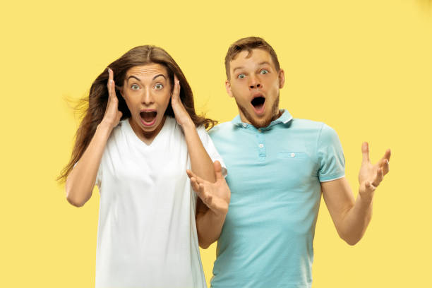 istock Beautiful couple isolated on yellow studio background 1149748982