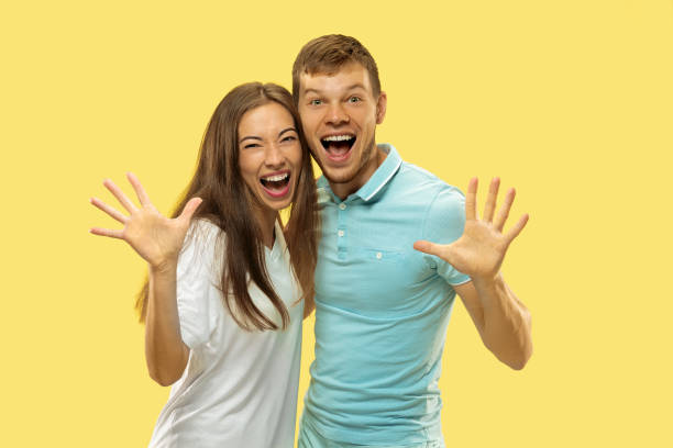 istock Beautiful couple isolated on yellow studio background 1149748999