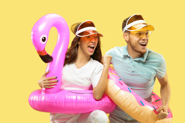 istock Beautiful couple isolated on yellow studio background 1149749027