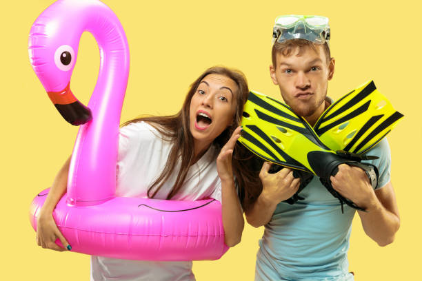 istock Beautiful couple isolated on yellow studio background 1149749032