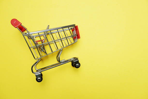 istock Mini trolley cart with space copy on yellow background 1149750447