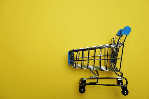istock Mini trolley cart with space copy on yellow background 1149750481