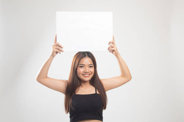 istock Young Asian woman with white blank sign. 1149750671