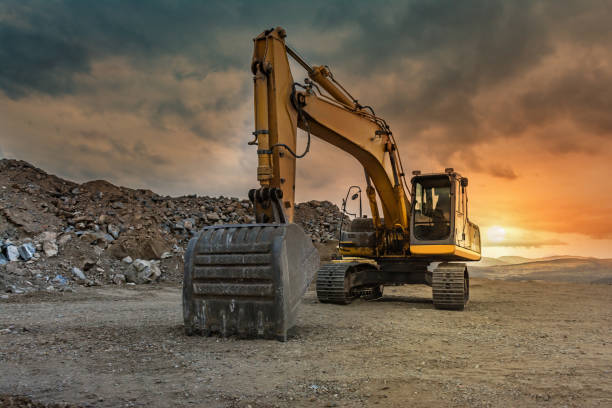istock Excavator at the end of a working day in a construction site 1149752335