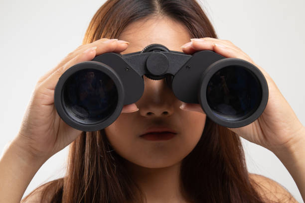 istock Young Asian woman with binoculars. 1149752459
