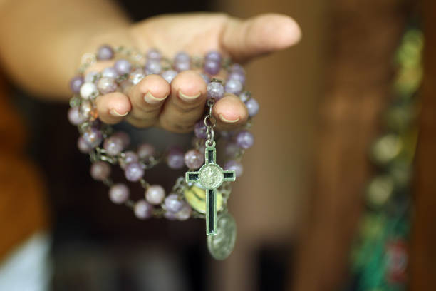 istock Purple Rosary in Hand. Prayer Lady. 1149752483