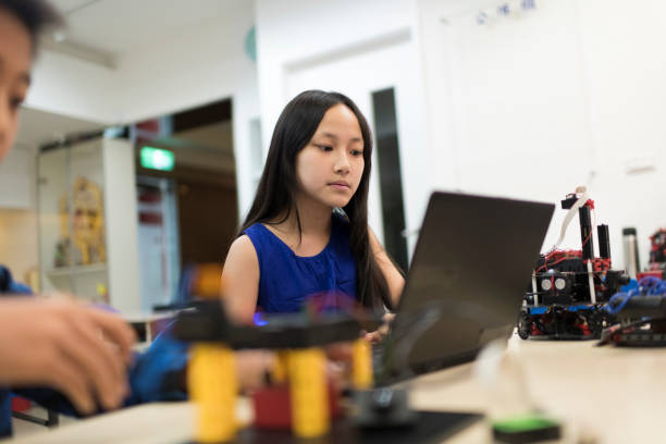istock Young girl working on her computer at school 1149753966