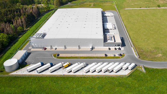 Loading bay, truck parking lot, industrial building, logistics - aerial view