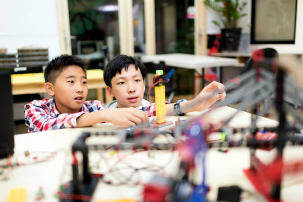 istock Two young boys building a robot in their science and technology lesson 1149755044