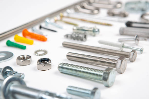 Bits and pieces from the hardware store: screws, bolts, fixings, nuts screws and nails on a white background. An assortment of carpenters material like screws, bolts, fixings, nuts screws and nails on a white background. hook of holland stock pictures, royalty-free photos & images