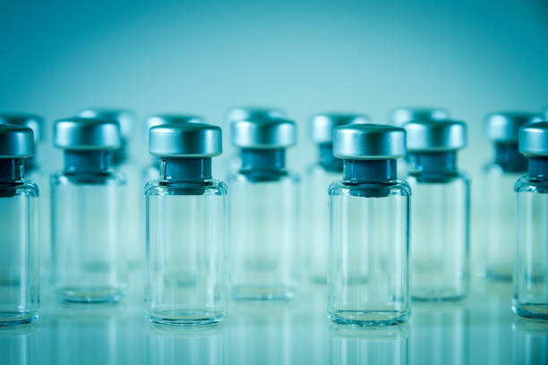 istock Vaccine glass bottles on blue background 1149757620