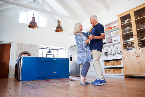 istock Senior Couple At Home Dancing In Kitchen Together 1149759177
