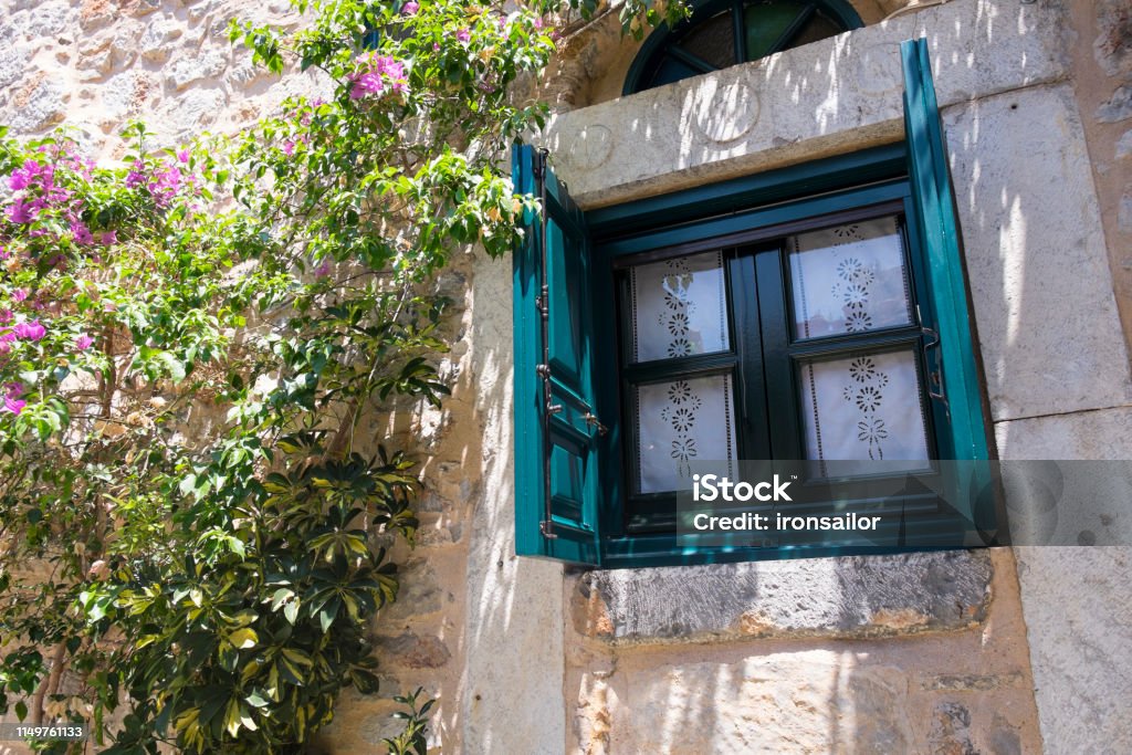 A Window in Narrow Streets of Medieval Town of Olimpi,  Chios Island, Greece Aegean Islands, Chios Island, shutter, Greek Islands, window Aegean Islands Stock Photo