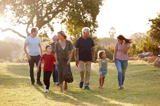 istock Multi-Generation Family Walking In Countryside Against Flaring Sun 1149761182