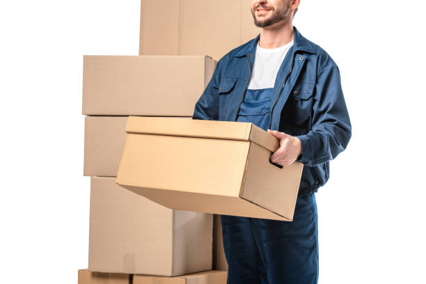 istock cropped view of mover in uniform carrying cardboard box isolated on white 1149766662