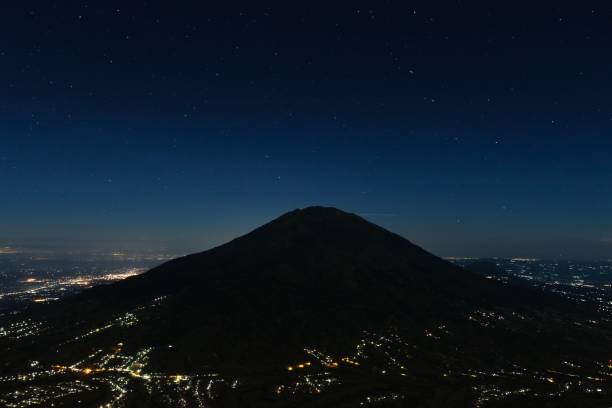 istock Night Merbabu volcano at Java island in Indonesia, from the slopes of Merapi volcano. 1149768055