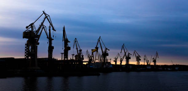 istock View on a shipyard with cranes at the sunset. 1149769612