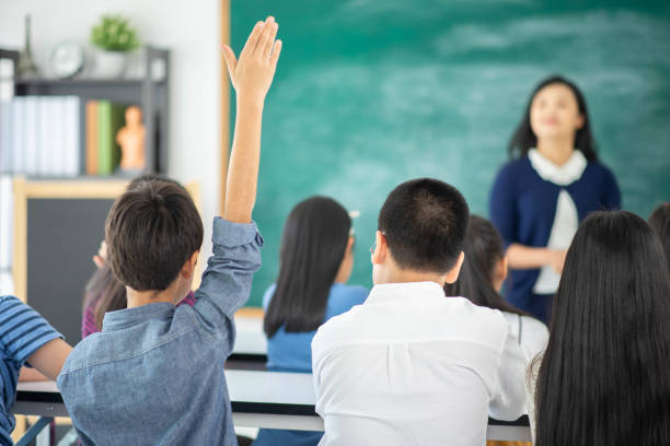 istock Portrait student looking at globe while listening to teacher with magnifying glass 1149783799