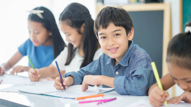 istock Asian primary student and teacher in the classroom 1149784036