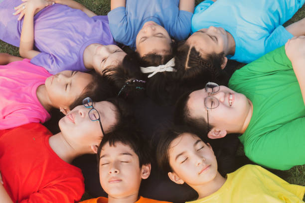 istock Group of student's friendship and team work lay down on the grass relaxing 1149784174
