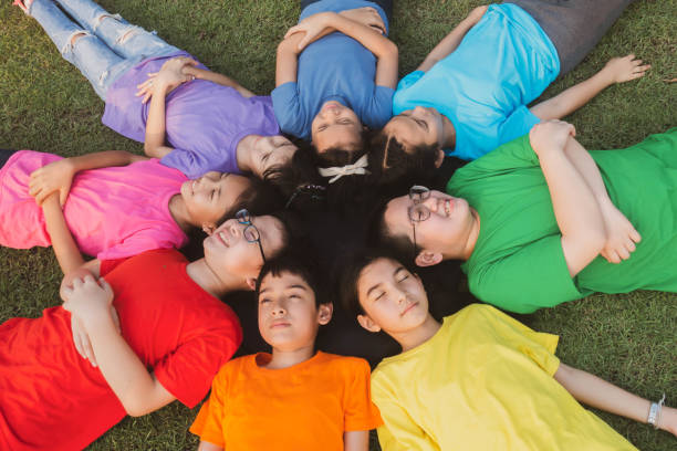 istock Group of student's friendship and team work lay down on the grass relaxing 1149784185