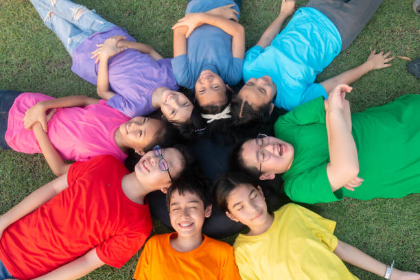 istock Group of student's friendship and team work lay down on the grass relaxing 1149784216